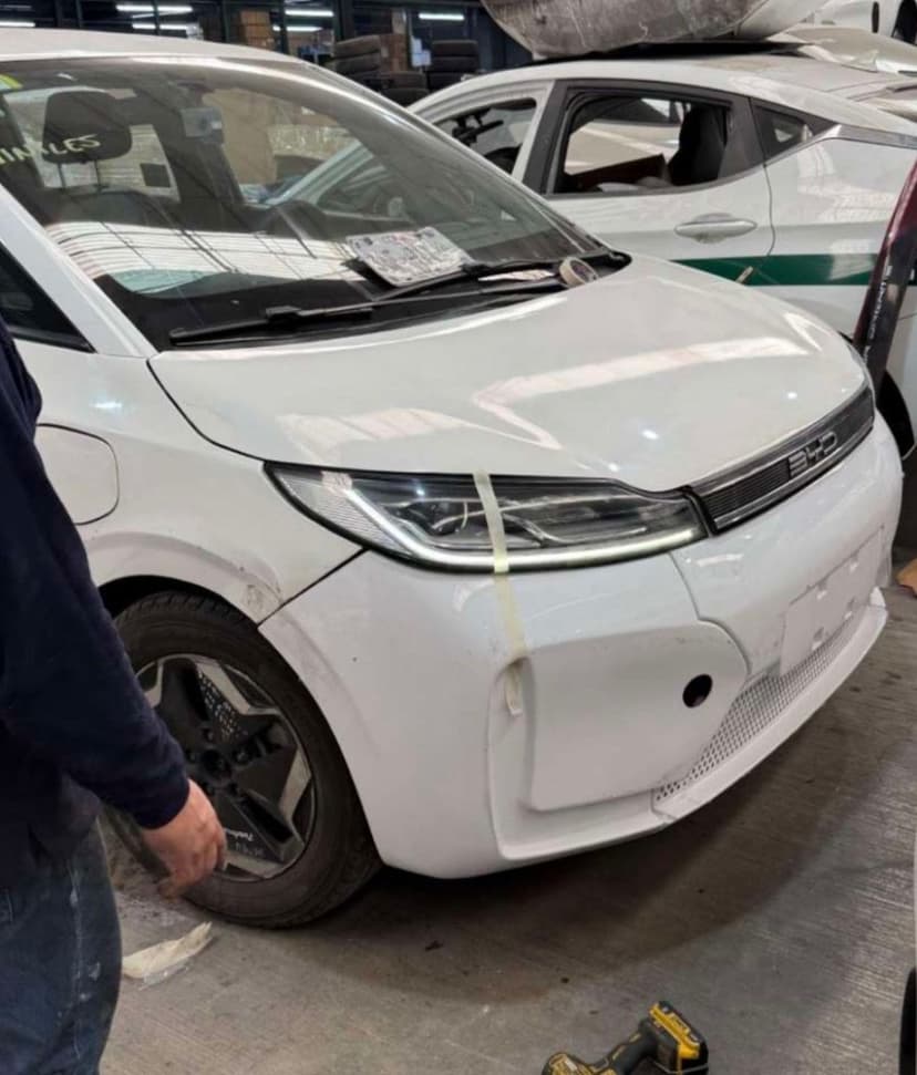 Fleet vehicle in workshop during bumper repair and fit-up